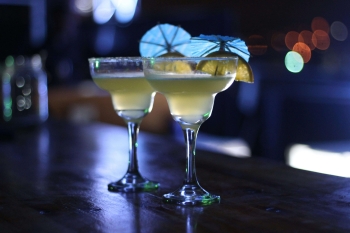 Two yellow cocktails on a table of a Westminster bar