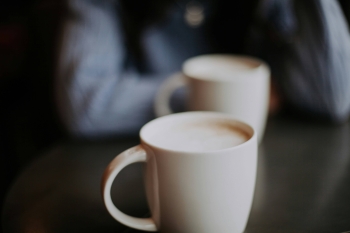 two cups of coffee on a table in a cafe