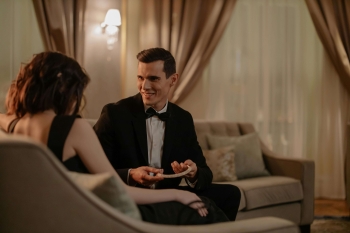 a man in a suit meeting an escort in a hotel