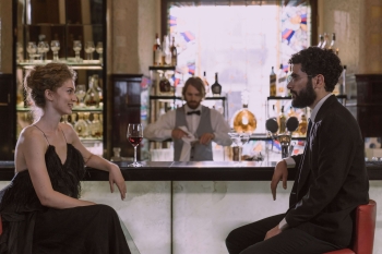 an escort and a client at a bar