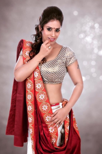 Nandini standing in a lavish traditional outfit