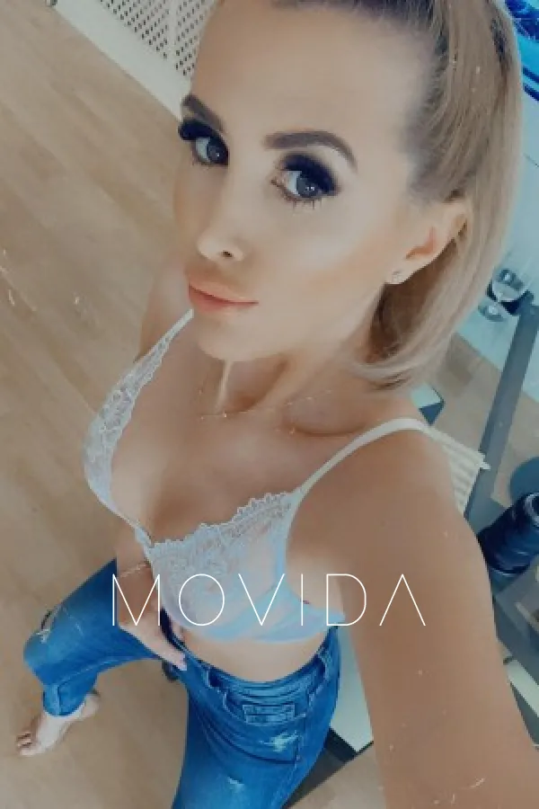 Alina taking a selfie wearing white bra and denim jeans Profile Image