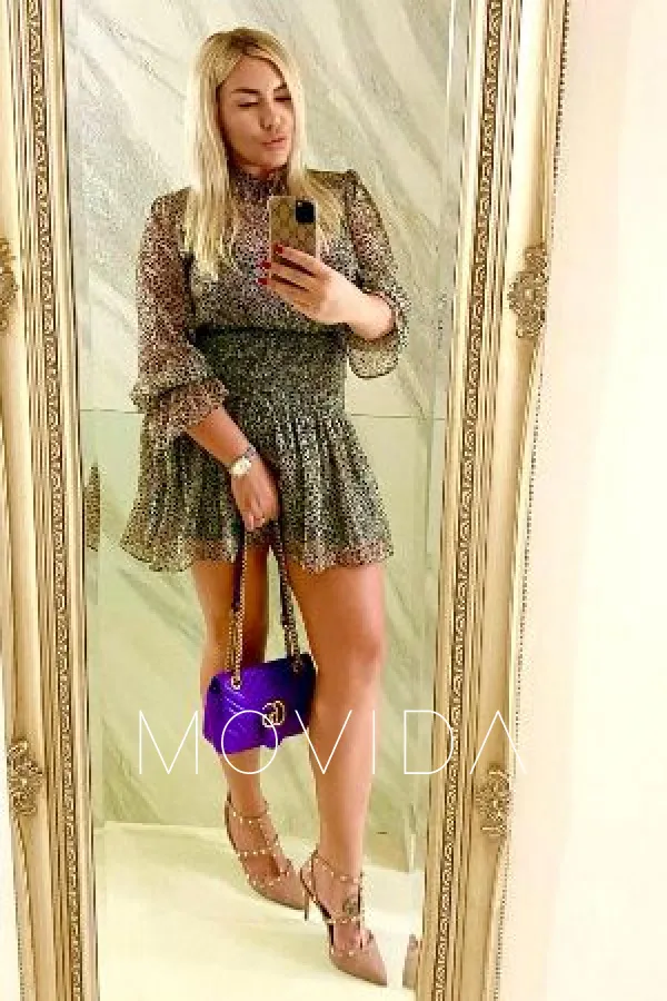 Clara taking a mirror selfie wearing a dress Profile Image