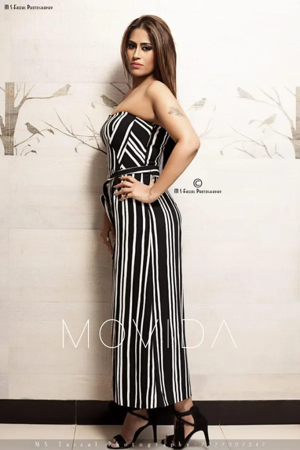 Nandini standing in a long stripy dress  Profile Image