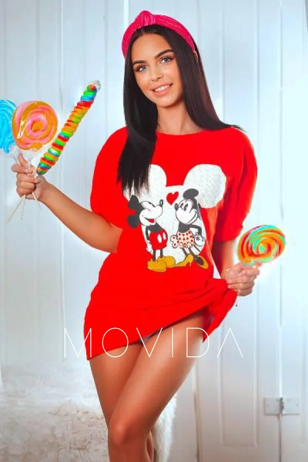 Rihana holding a ton of sweets in a red shirt  Profile Image
